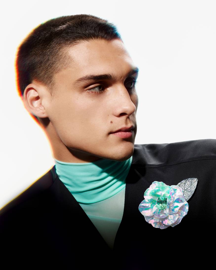 model wearing a flower brooch from the carte blanche holographic collection 