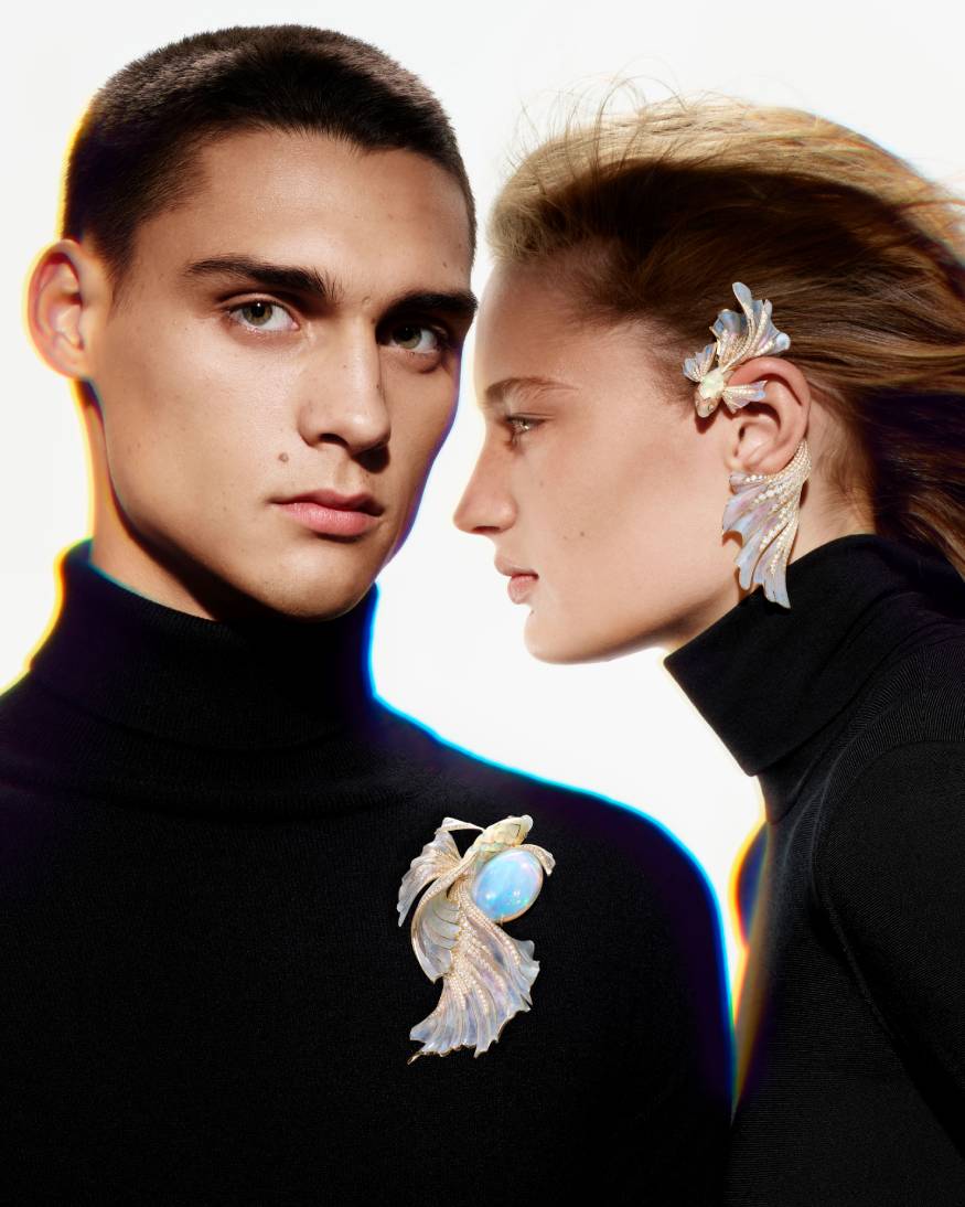 models wearing a fish earring & brooch from the carte blanche holographic collection 